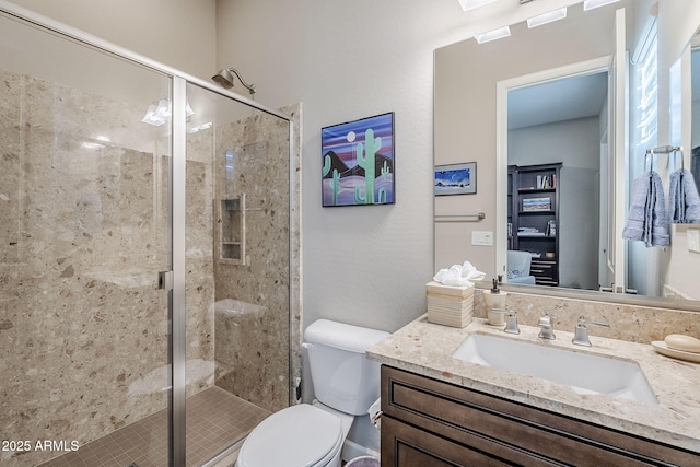 bathroom featuring vanity, toilet, and walk in shower