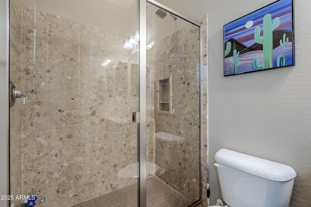 bathroom with an enclosed shower and toilet