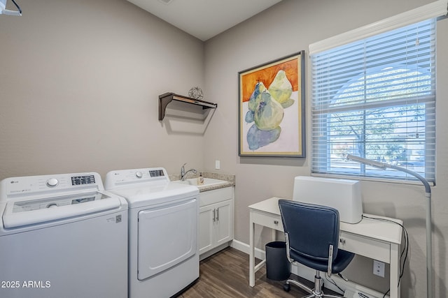 clothes washing area featuring dark hardwood / wood-style floors, cabinets, independent washer and dryer, and sink