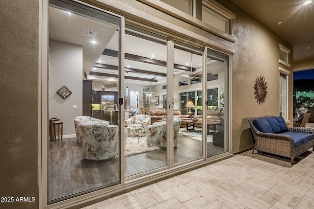 doorway with ceiling fan