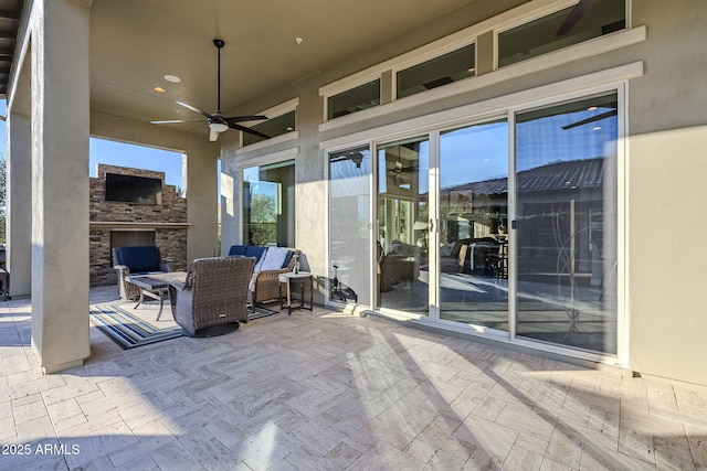 view of patio / terrace with ceiling fan and an outdoor living space