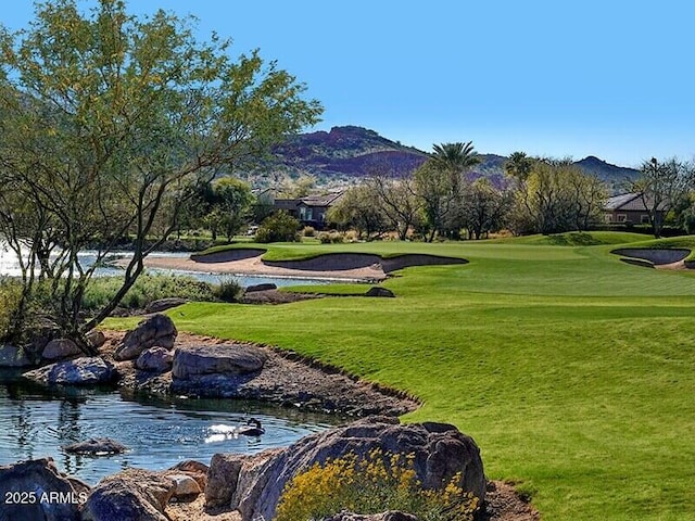 surrounding community with a lawn and a mountain view