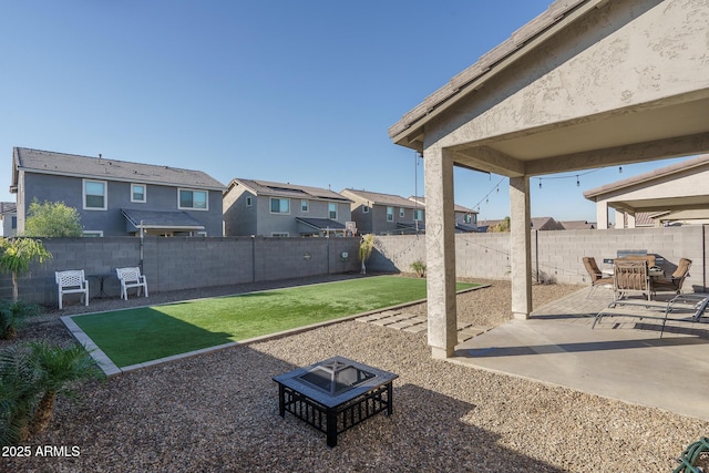 view of yard with a patio and an outdoor fire pit