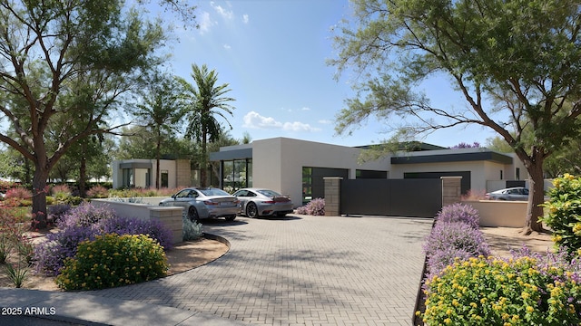 view of front of home featuring a gate and stucco siding