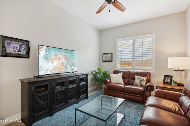 living area featuring ceiling fan and baseboards