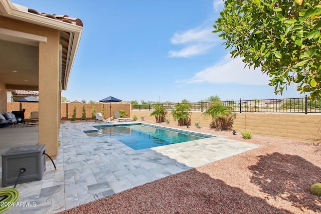 view of swimming pool with a fenced backyard, a fenced in pool, and a patio