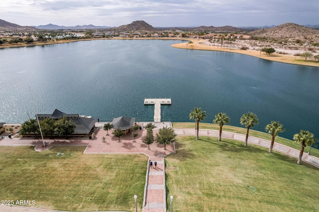 birds eye view of property with a water and mountain view