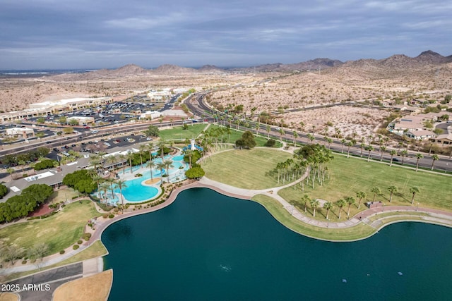 birds eye view of property with a water and mountain view