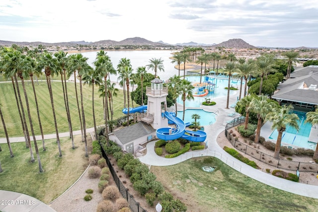 birds eye view of property with a water and mountain view