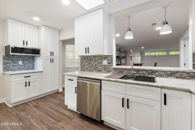 kitchen featuring pendant lighting, appliances with stainless steel finishes, dark wood-type flooring, white cabinets, and a sink