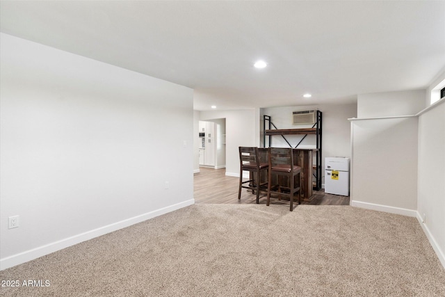 interior space featuring recessed lighting, carpet flooring, a dry bar, and baseboards