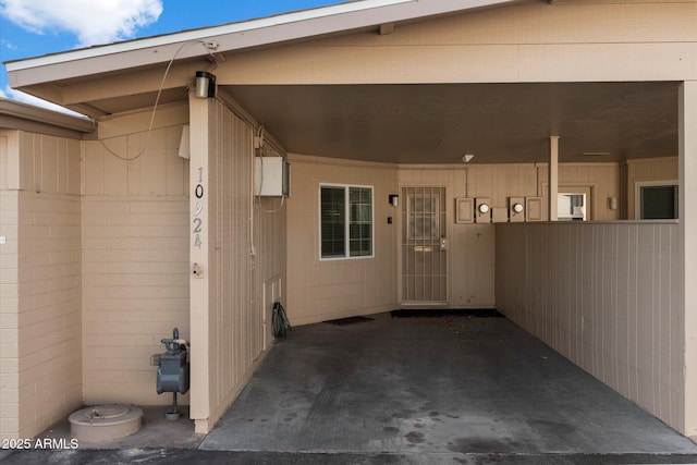 entrance to property featuring an attached carport