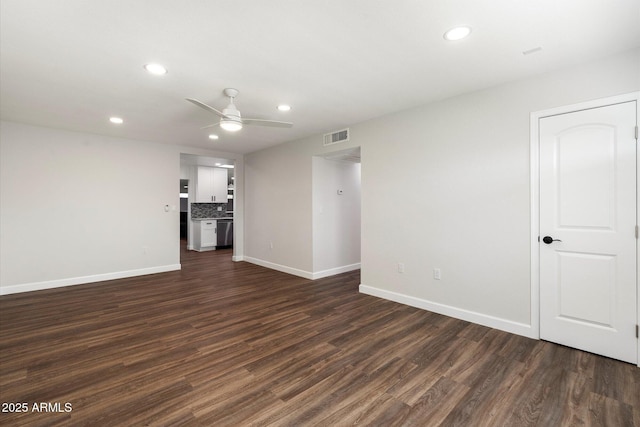 empty room with dark wood-type flooring, recessed lighting, visible vents, and ceiling fan