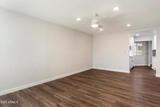 empty room featuring ceiling fan, baseboards, dark wood finished floors, and recessed lighting