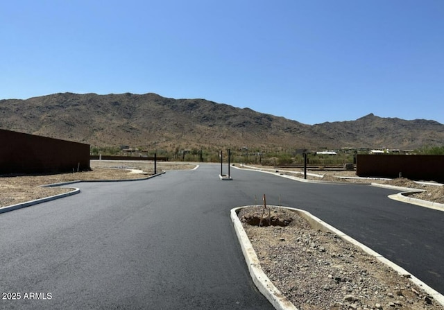 view of road with curbs and a mountain view