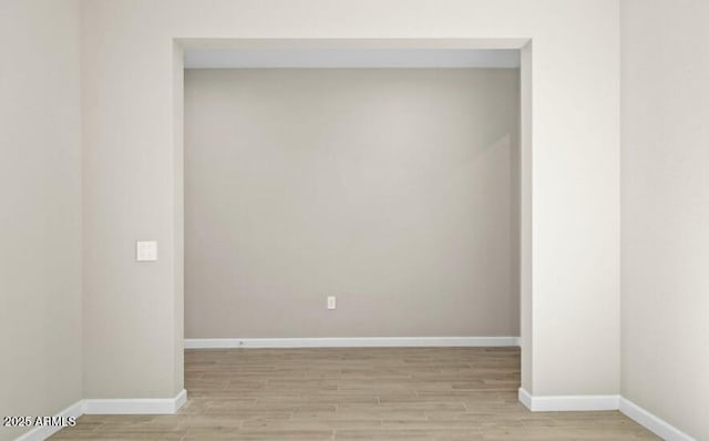 empty room featuring light wood-style flooring and baseboards