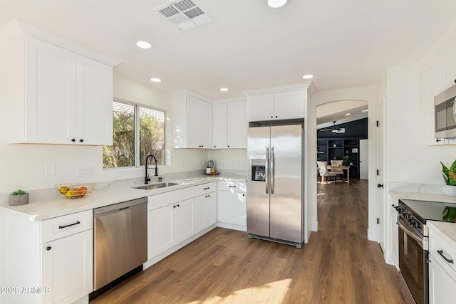 kitchen featuring sink, white cabinets, stainless steel appliances, and dark hardwood / wood-style floors