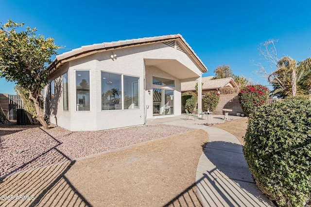 rear view of property featuring a patio