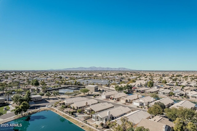 birds eye view of property with a water and mountain view