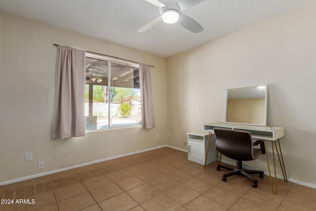 home office with light tile patterned floors, a textured ceiling, and ceiling fan