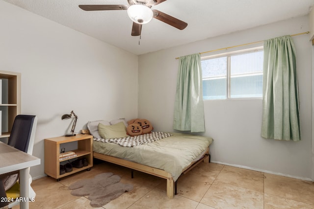 tiled bedroom featuring ceiling fan