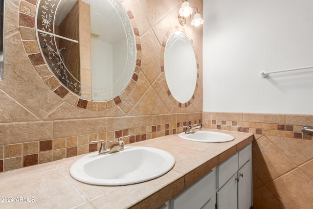 bathroom featuring backsplash, vanity, and tile walls