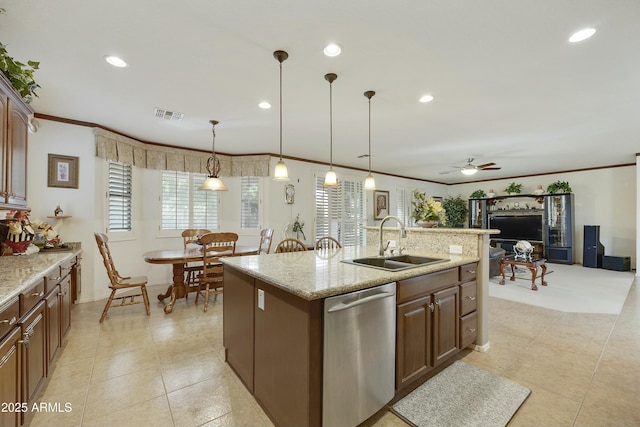 kitchen featuring sink, crown molding, dishwasher, a kitchen island with sink, and hanging light fixtures