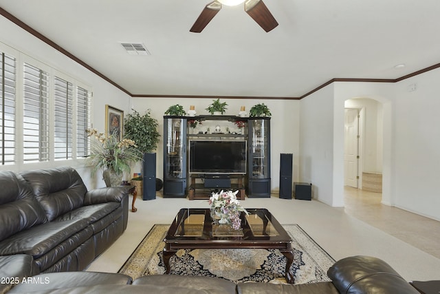 living room with ornamental molding and ceiling fan