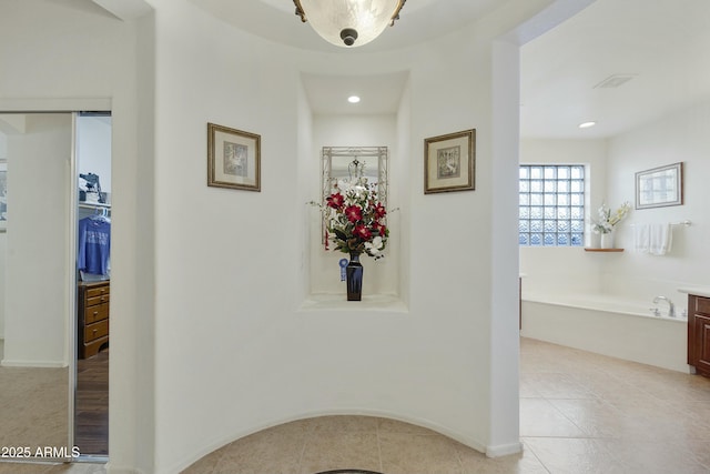 hall featuring light tile patterned floors