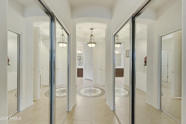 hall featuring light tile patterned floors