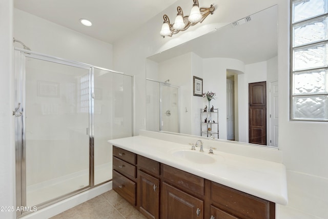 bathroom featuring vanity, an enclosed shower, and tile patterned flooring