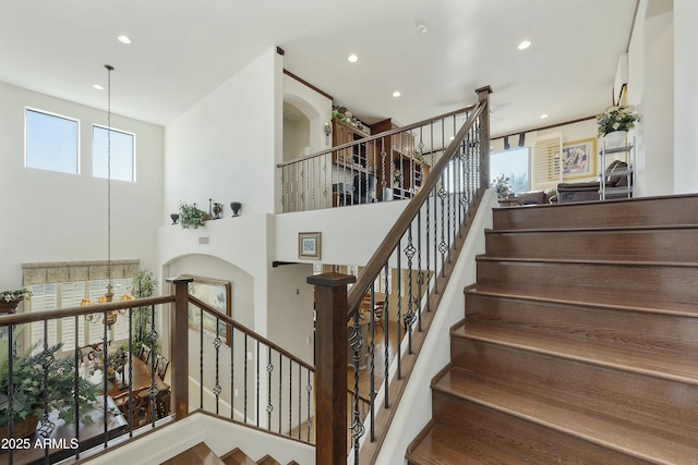 staircase with a towering ceiling