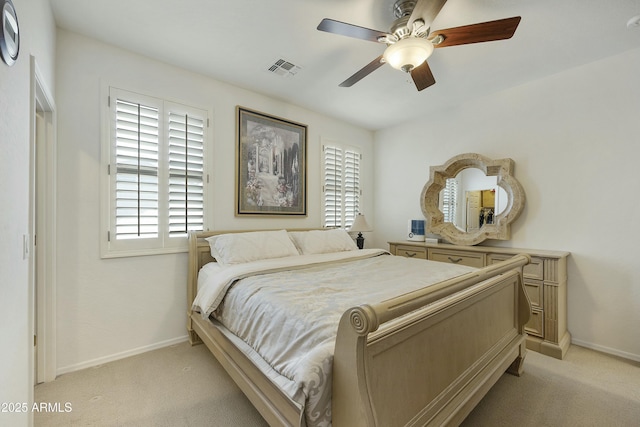 bedroom featuring light colored carpet and ceiling fan