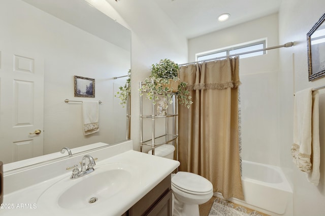 full bathroom featuring vanity, shower / bath combo with shower curtain, and toilet