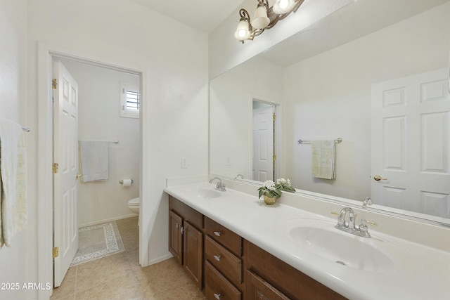 bathroom with vanity, tile patterned floors, and toilet