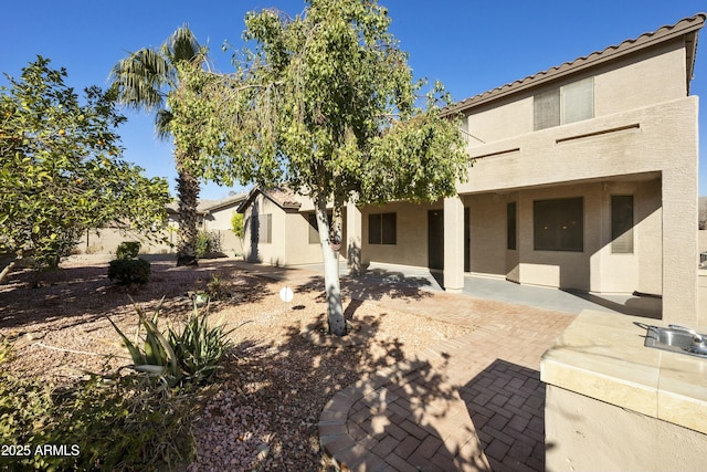 back of house with a patio