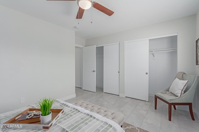 bedroom featuring ceiling fan and two closets