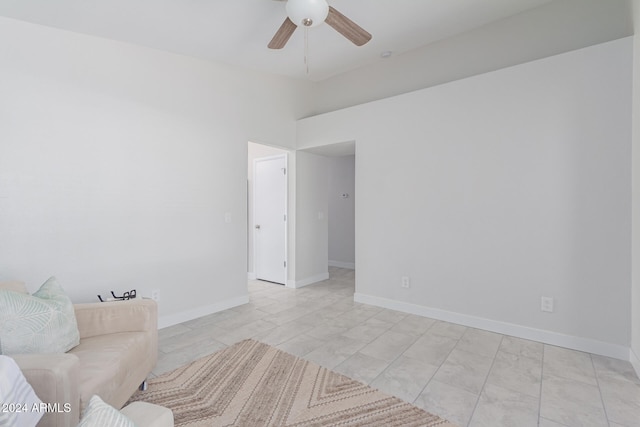 empty room featuring light tile patterned floors and ceiling fan