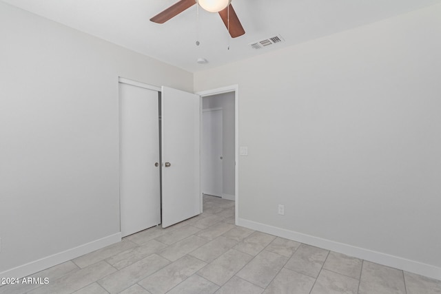 unfurnished bedroom with a closet and ceiling fan