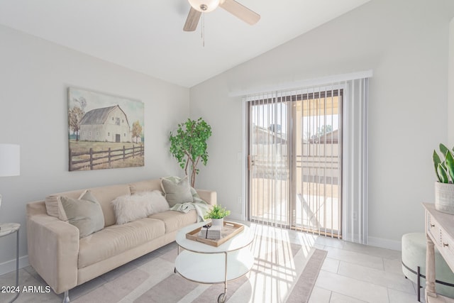 living room featuring ceiling fan, light tile patterned floors, and vaulted ceiling