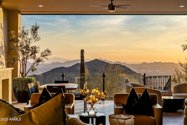exterior space featuring a mountain view, a ceiling fan, and outdoor dining space