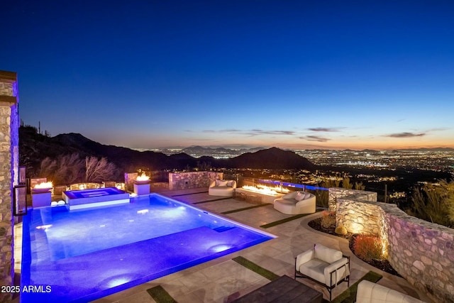 view of swimming pool with a mountain view and a patio