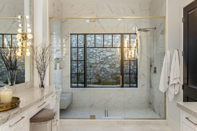 bathroom featuring a marble finish shower and vanity