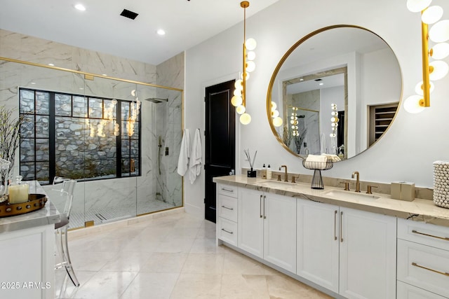 full bathroom with double vanity, a marble finish shower, a sink, and recessed lighting