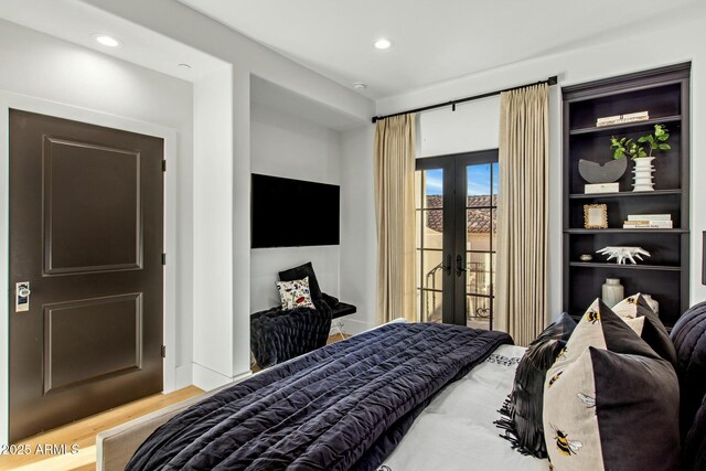 bedroom featuring french doors, recessed lighting, wood finished floors, and access to exterior