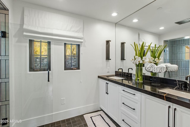 bathroom featuring recessed lighting, visible vents, a sink, and double vanity