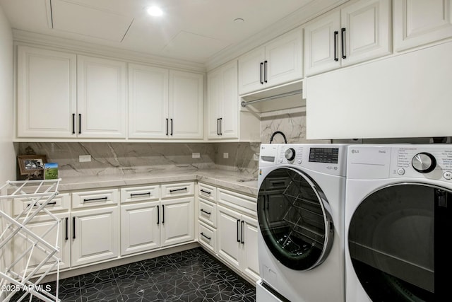 washroom with cabinet space and washer and dryer