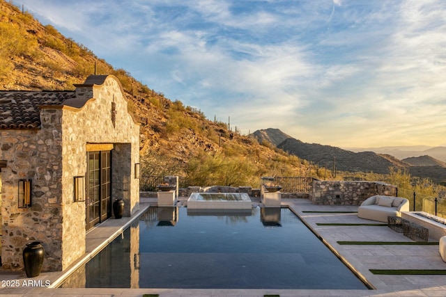 view of pool with a patio area and a mountain view