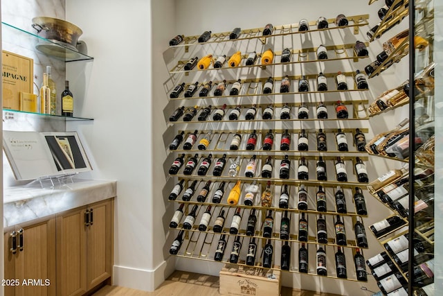 wine cellar with baseboards and light wood finished floors