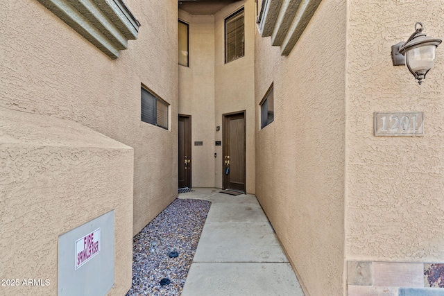 property entrance featuring stucco siding